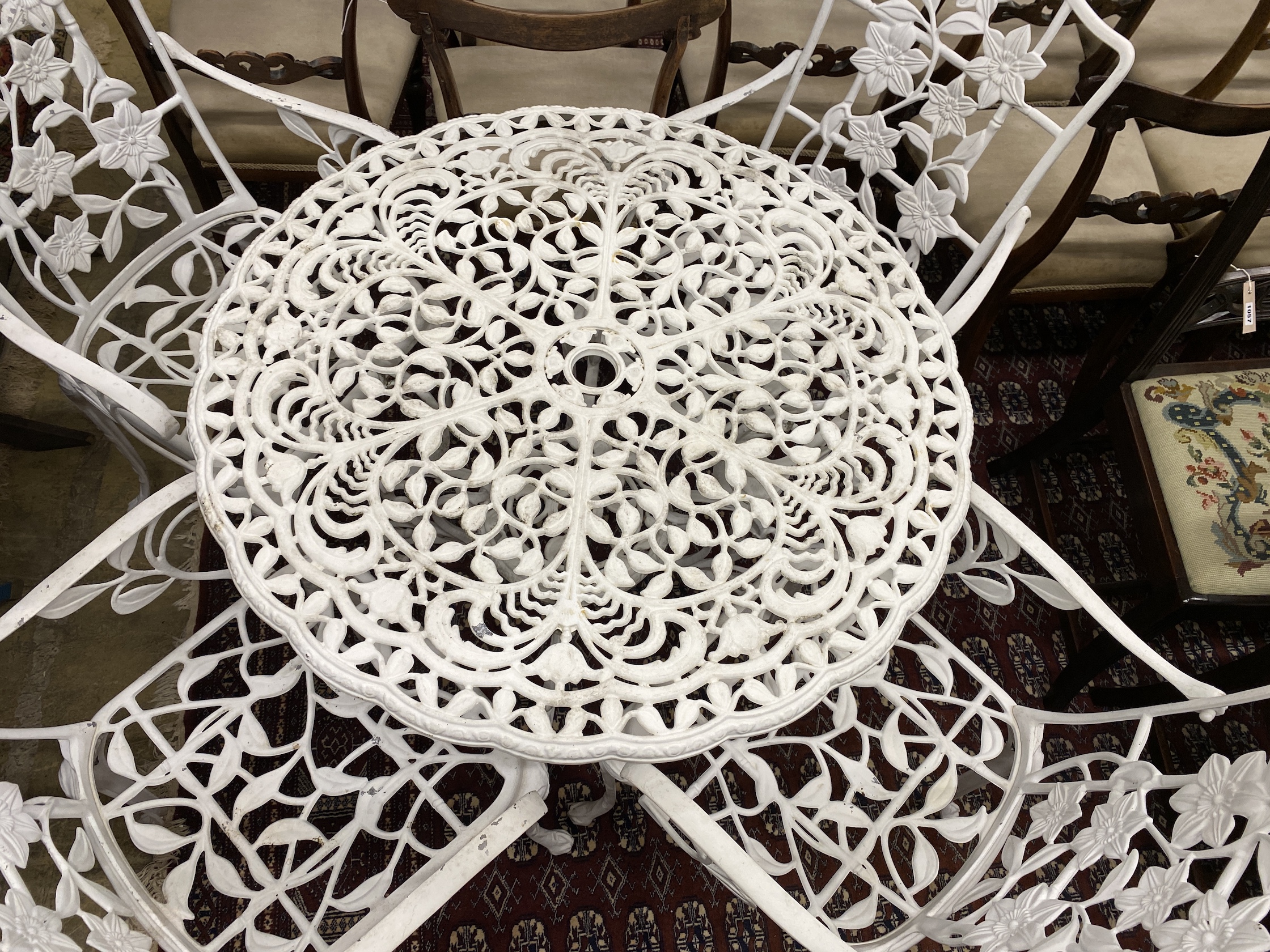 A Victorian style aluminium circular garden table, diameter 90cm, height 69cm and four chairs